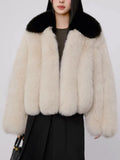 Full body shot of woman wearing cream and black faux fur jacket