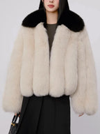 Full body shot of woman wearing cream and black faux fur jacket