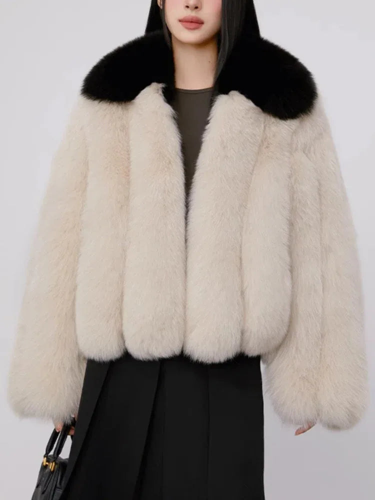Full body shot of woman wearing cream and black faux fur jacket