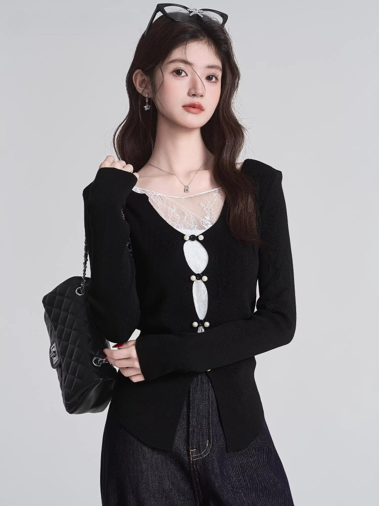 Woman with a black quilted handbag wearing a black knit top