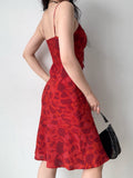 Back view of a woman in a red floral print midi dress