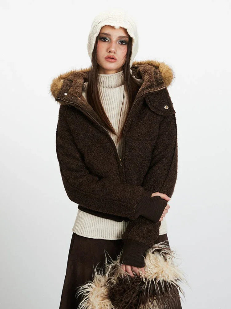 Close-up front view of a model wearing a brown textured bomber jacket with a faux fur trimmed hood