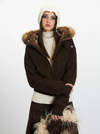 Close-up front view of a model wearing a brown textured bomber jacket with a faux fur trimmed hood