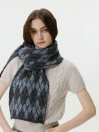 Woman posing with a gray and black argyle knit scarf