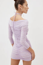 Back view of a lavender ruched mini dress with an off-the-shoulder design and halter neck strap