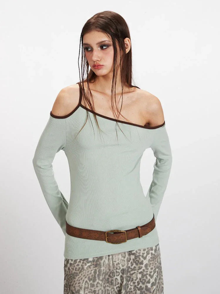 Front view of a model in a light green ribbed knit one-shoulder top, emphasizing the garment's details.