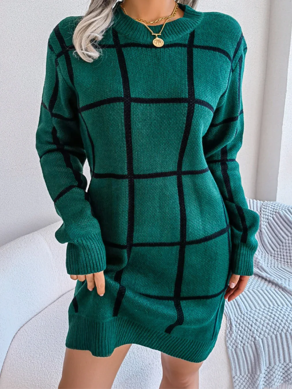 woman wearing a green and black plaid knit shift dress