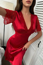 Close-up of lace detail on the V-neck and sleeves of a satin dress