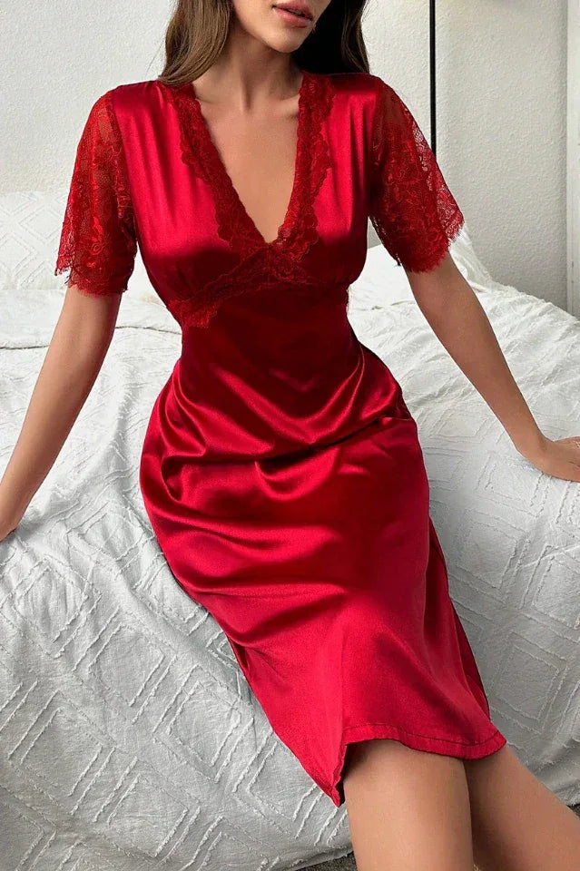 Back view of a red satin midi dress with a waist tie