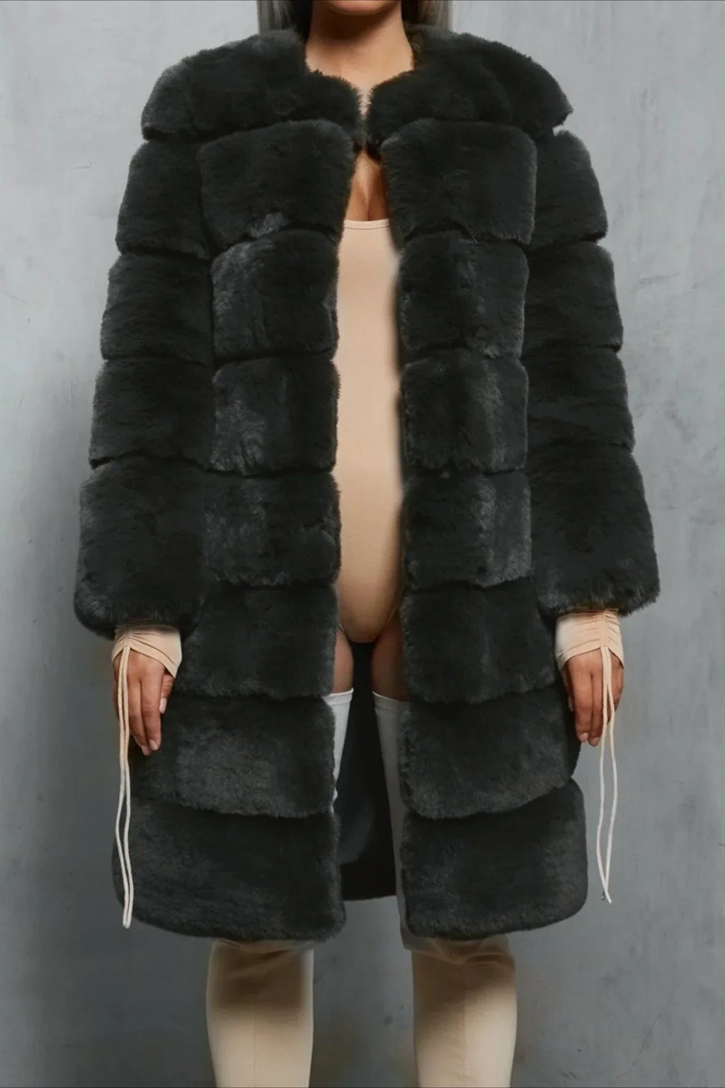 Woman in a dark grey faux fur coat