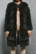 Woman in a dark grey faux fur coat
