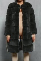 Woman in a dark grey faux fur coat