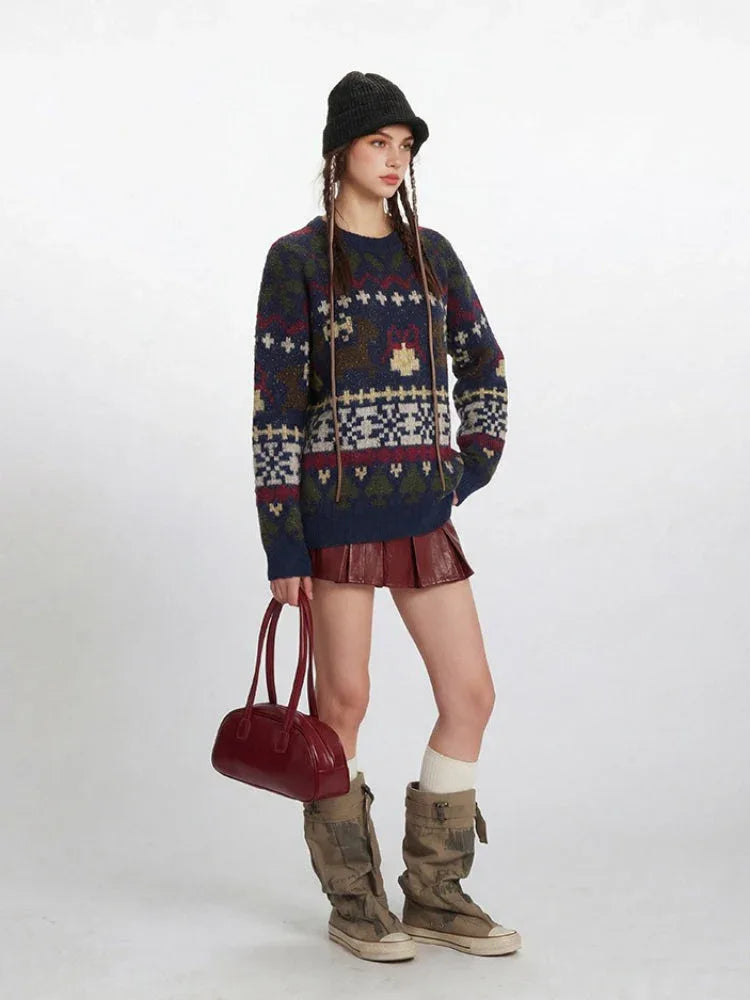 Woman wearing a navy blue knit sweater with a Fair Isle pattern featuring reindeer and snowflake motifs, paired with a red mini skirt and beige boots.