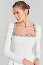 Close-up of the crystal-embellished square neckline on a white dress