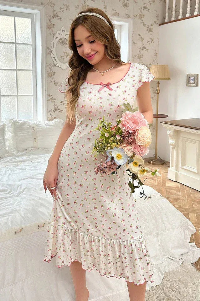Woman holding a bouquet of flowers while wearing a floral print nightgown