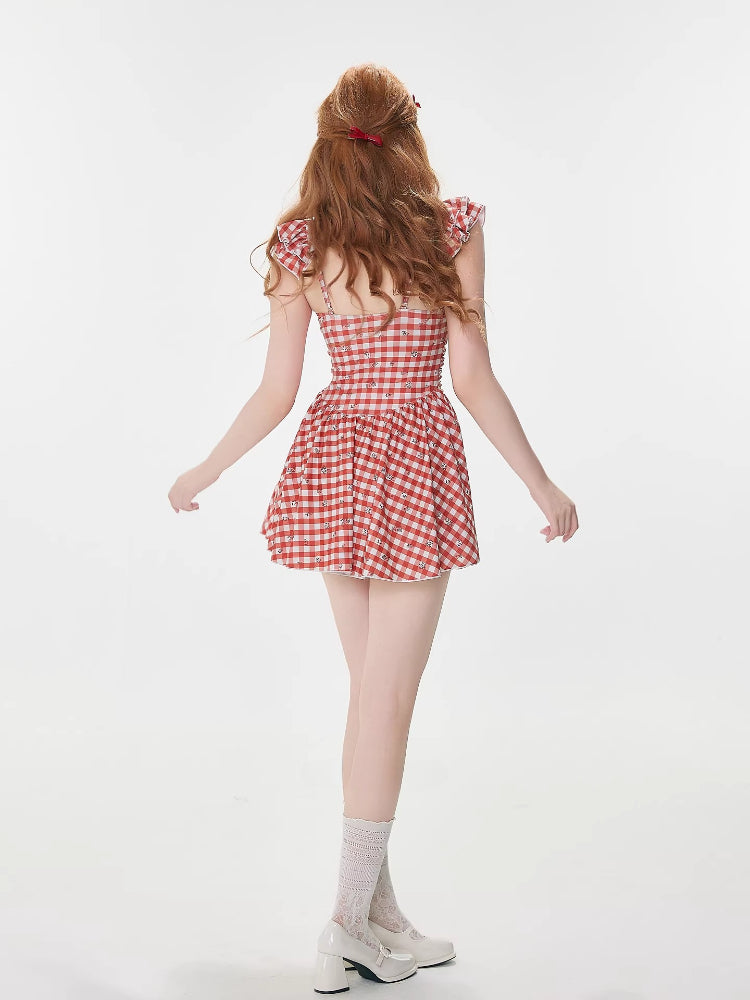 Back view of a woman in a red and white gingham dress