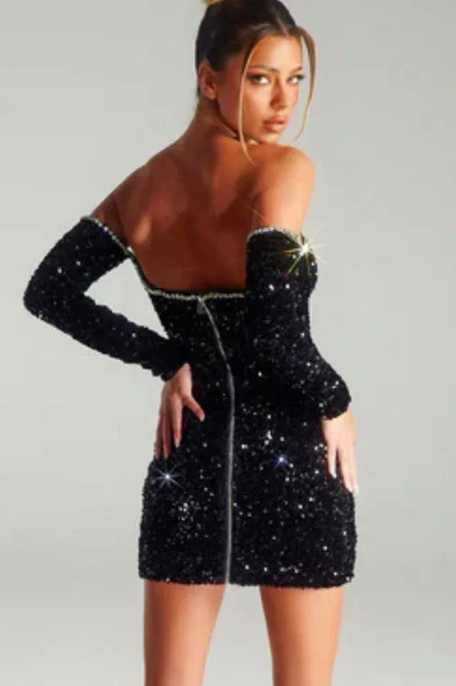Back view of a model in a black sequined off-the-shoulder mini dress
