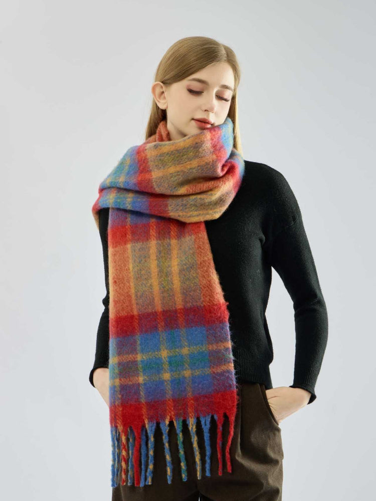 Woman with hands in pockets, wearing a plaid scarf