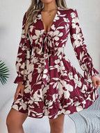 Woman wearing a burgundy floral tie-front mini dress