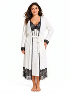 Woman wearing a white robe with black lace trim over a white slip dress with black lace top