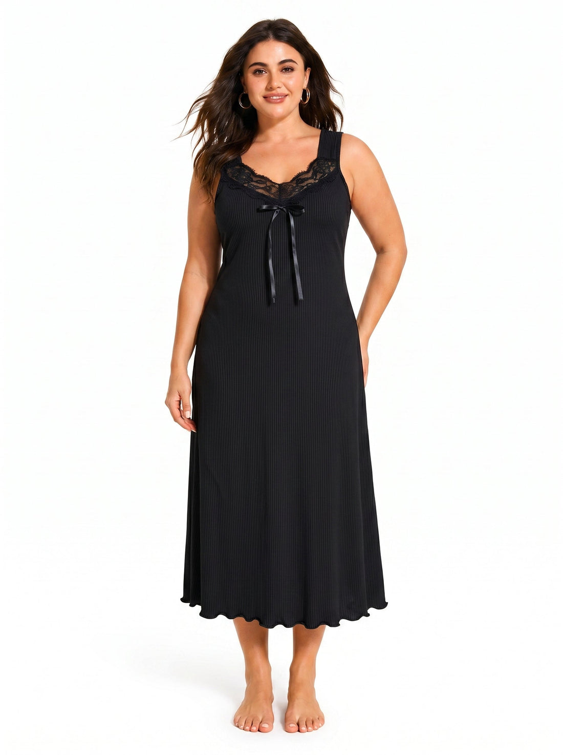 Woman wearing a black sleeveless ribbed knit nightgown with lace trim and a bow accent