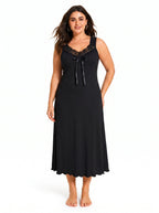 Woman wearing a black sleeveless ribbed knit nightgown with lace trim and a bow accent