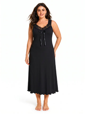 Woman wearing a black sleeveless ribbed knit nightgown with lace trim and a bow accent