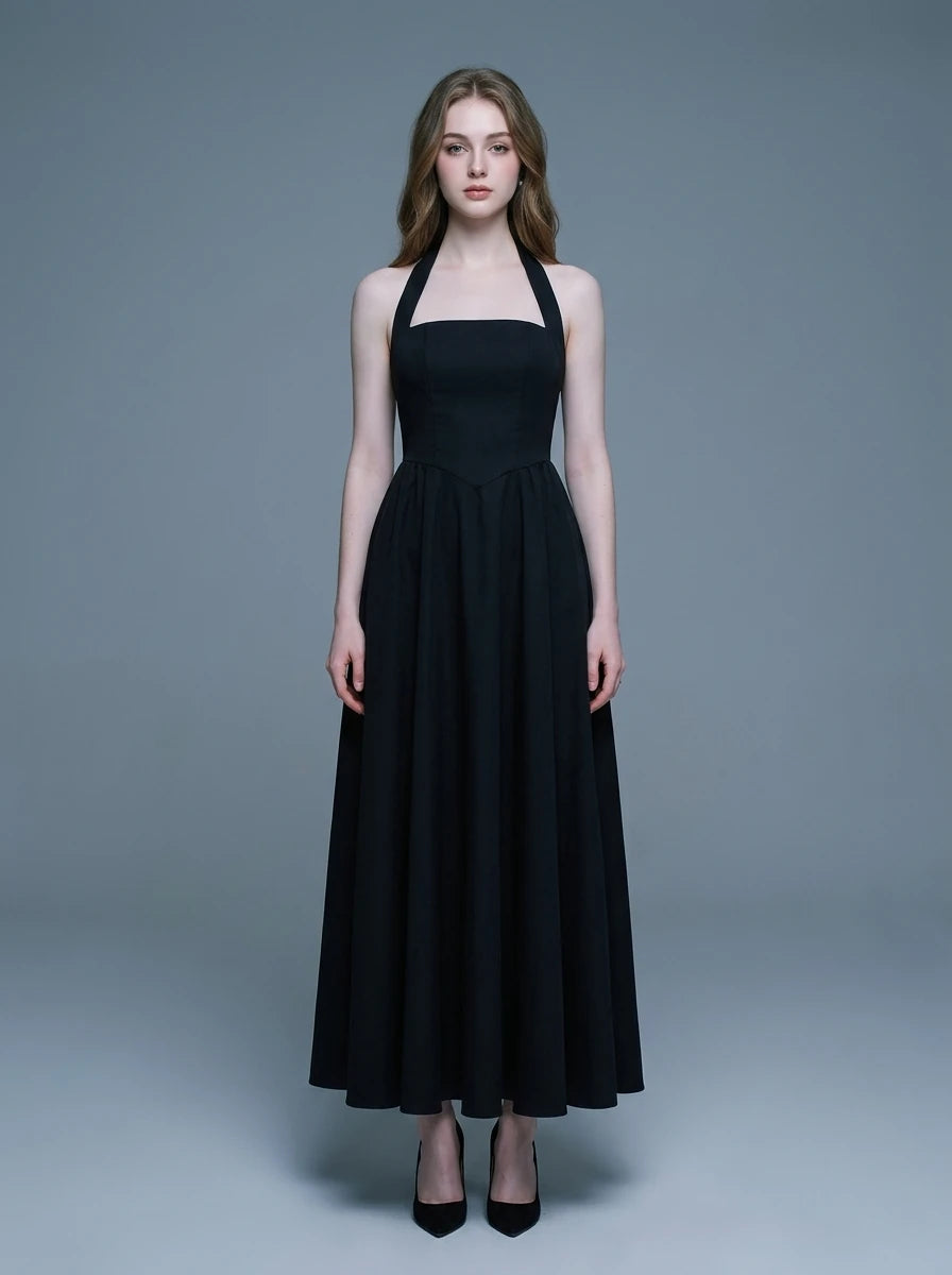 woman wearing a black midi halter dress with a square neckline