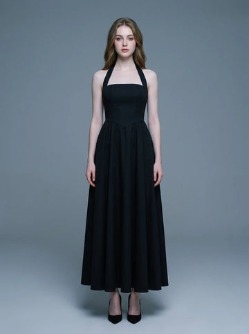 woman wearing a black midi halter dress with a square neckline