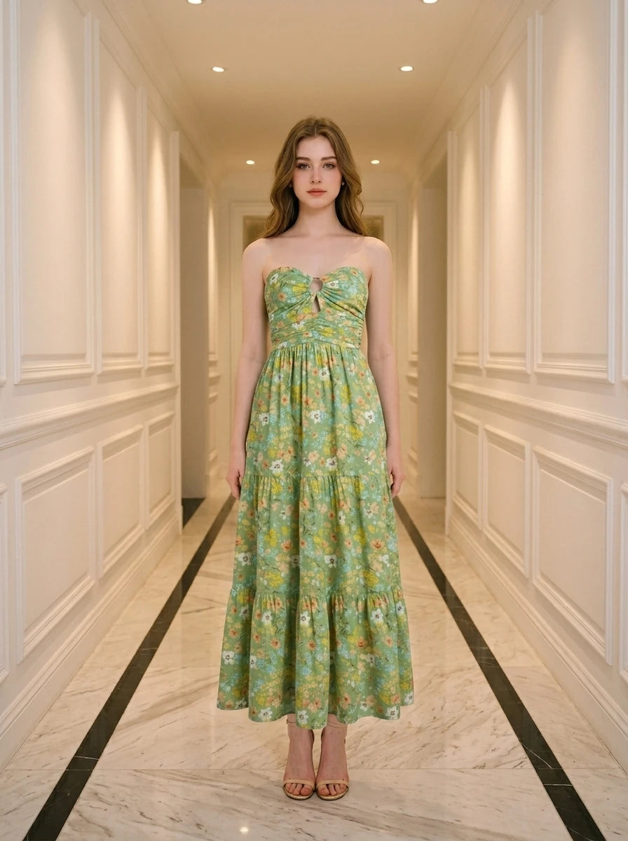 Woman wearing a green floral print strapless maxi dress standing in a hallway.