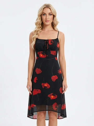 Woman wearing a black midi dress with a red floral print, spaghetti straps, and a tie-front bodice
