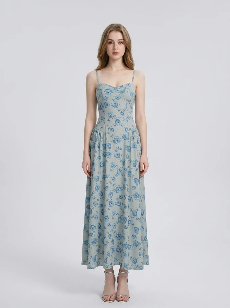 Woman wearing a light blue floral print midi dress with spaghetti straps