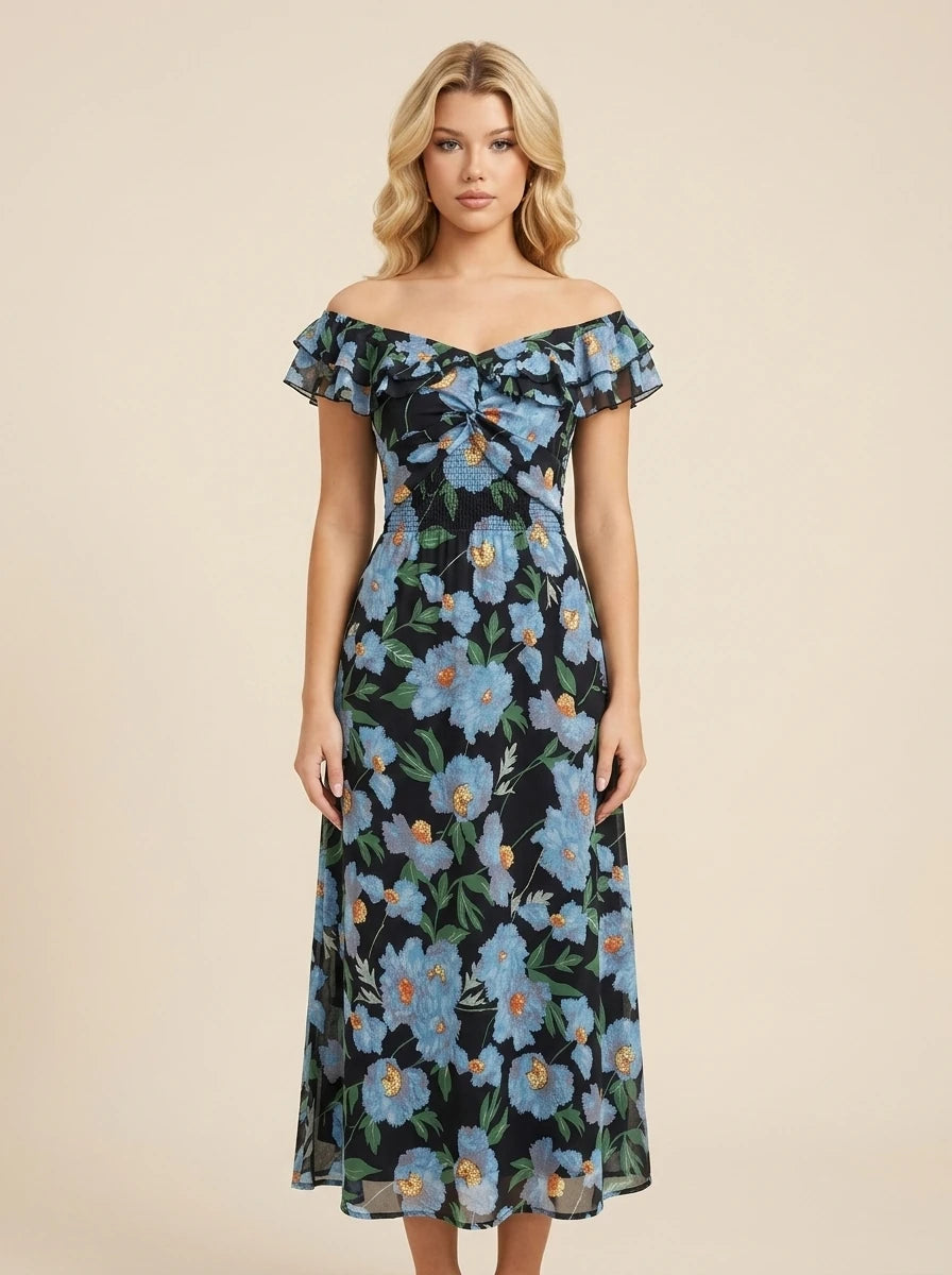 Woman wearing a black floral print off-the-shoulder midi dress with blue flowers and ruffle trim