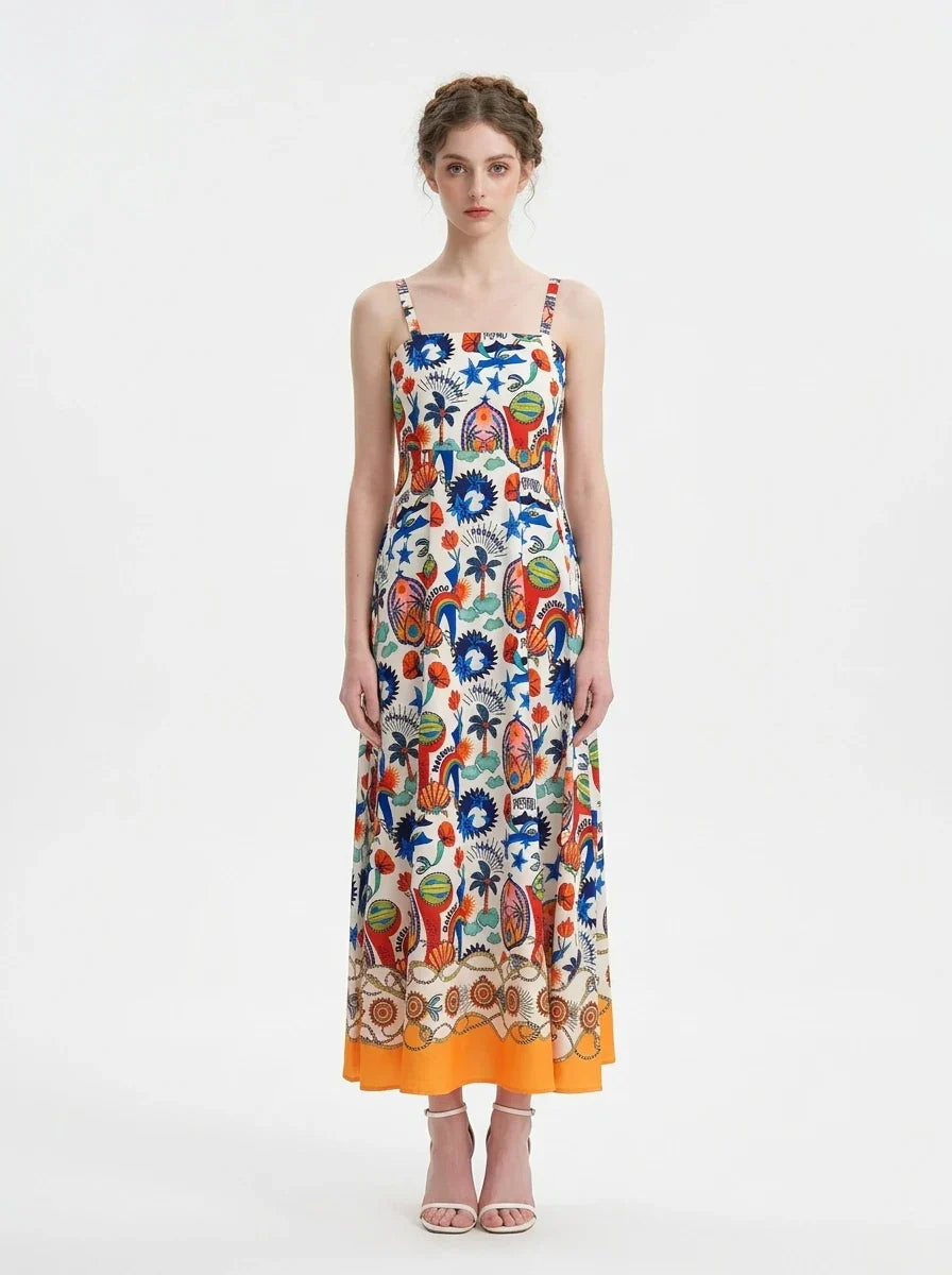 Woman wearing a vibrant printed midi dress with spaghetti straps and a square neckline.