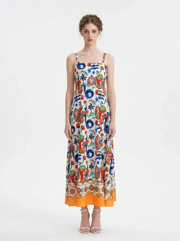Woman wearing a vibrant printed midi dress with spaghetti straps and a square neckline.