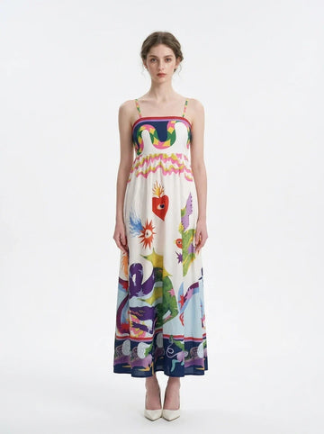 Woman wearing a white midi dress with a colorful graphic print and spaghetti straps from the front