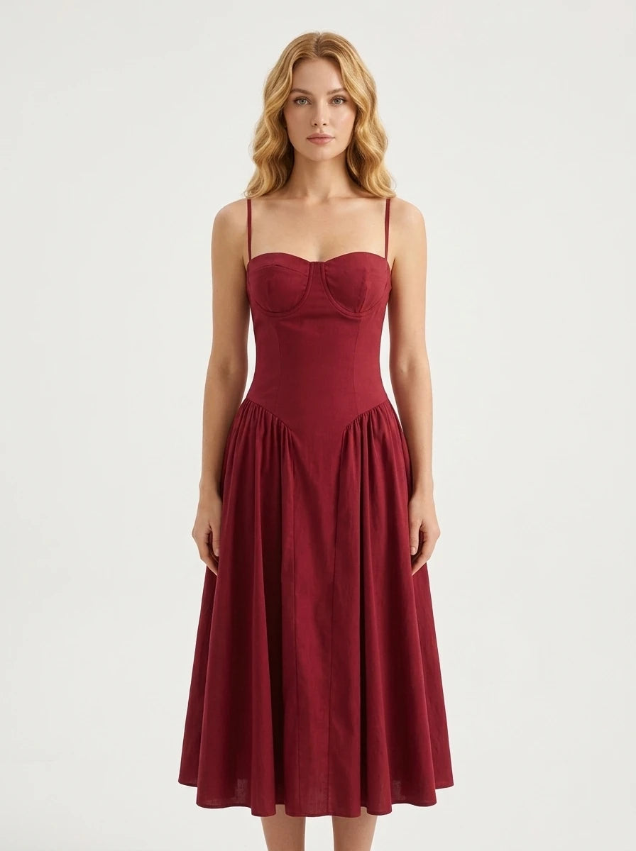 Woman wearing a deep red linen blend midi dress with spaghetti straps and a sweetheart neckline
