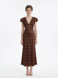 Model wearing a brown polka dot midi dress with a v-neckline and ruffled sleeves.