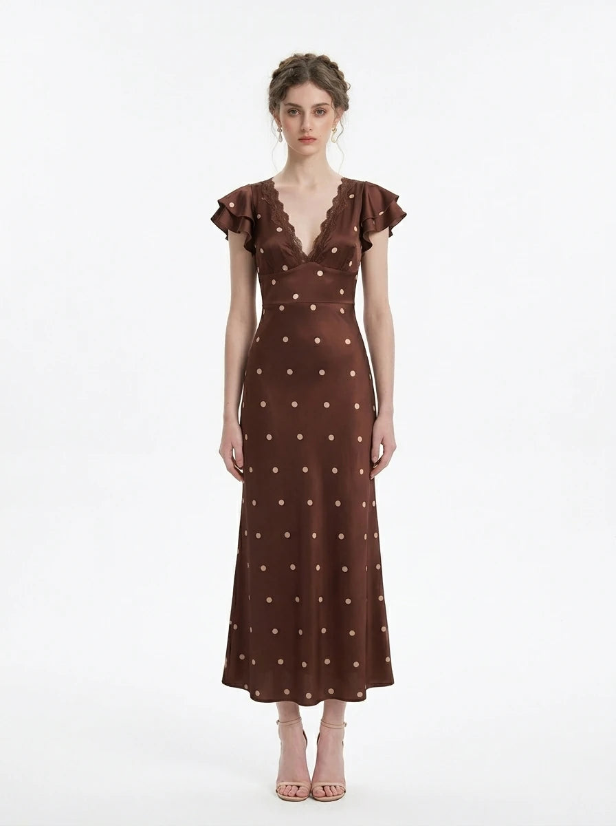 Model wearing a brown polka dot midi dress with a v-neckline and ruffled sleeves.