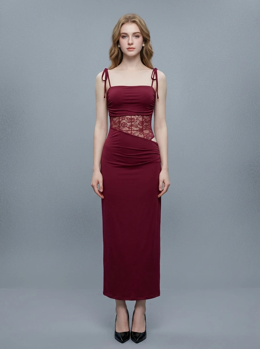 Woman wearing a long burgundy dress with a square neckline and lace detailing on the bodice.