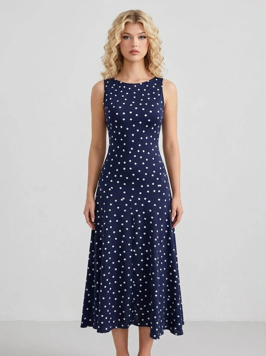 Woman wearing a navy blue polka dot midi dress
