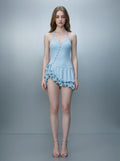 Woman wearing a light blue ruffled halter dress