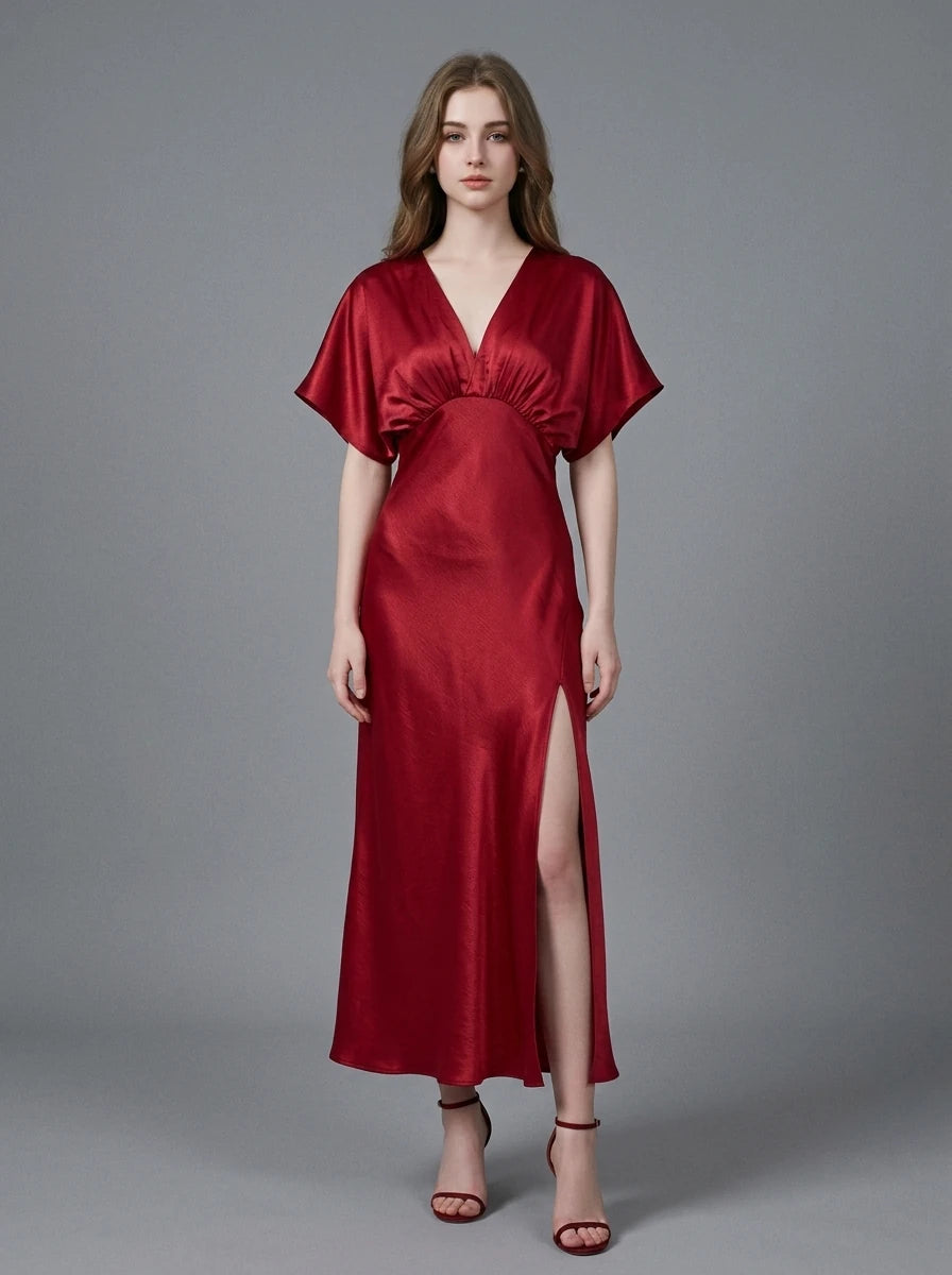 Woman in a red satin V-neck dress with kimono sleeves and a high slit, front view