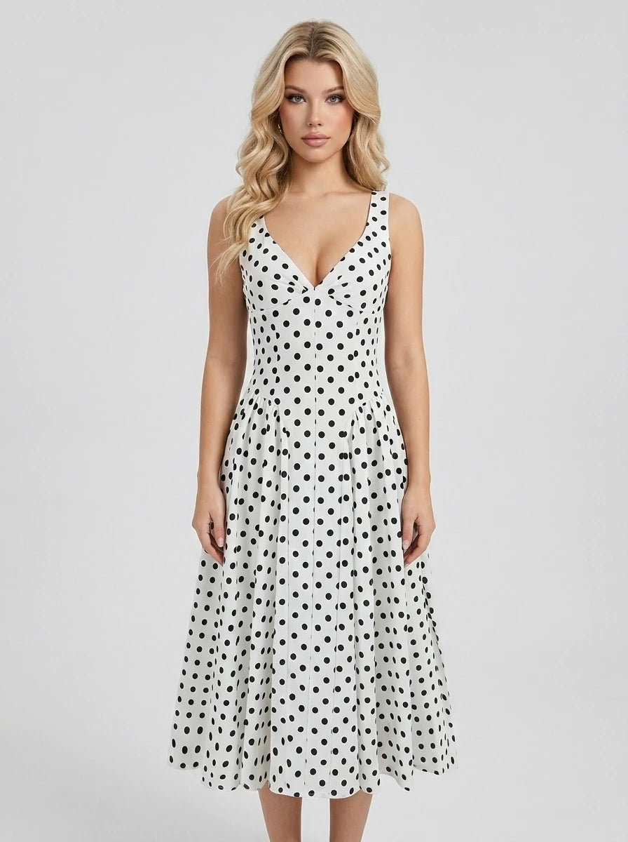Woman wearing a white sleeveless V-neck dress with black polka dots