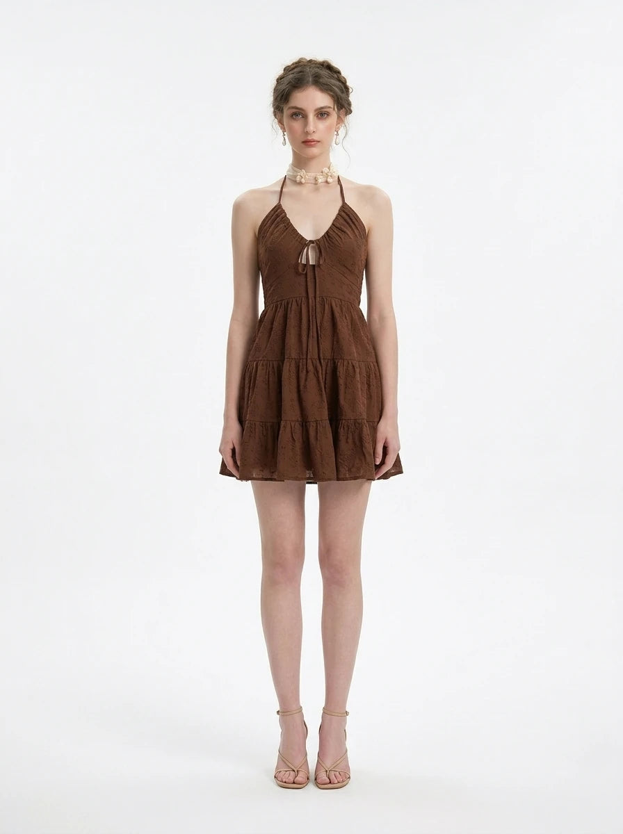 Woman wearing a brown halter neck tiered mini dress