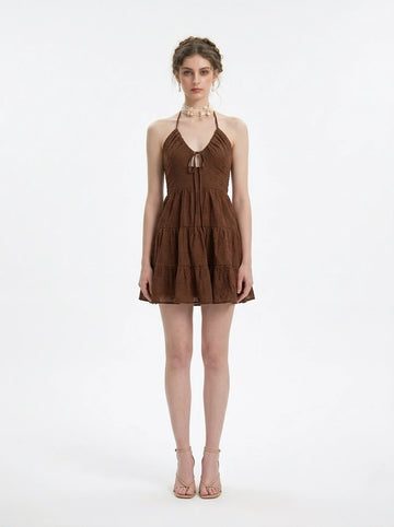 Woman wearing a brown halter neck tiered mini dress