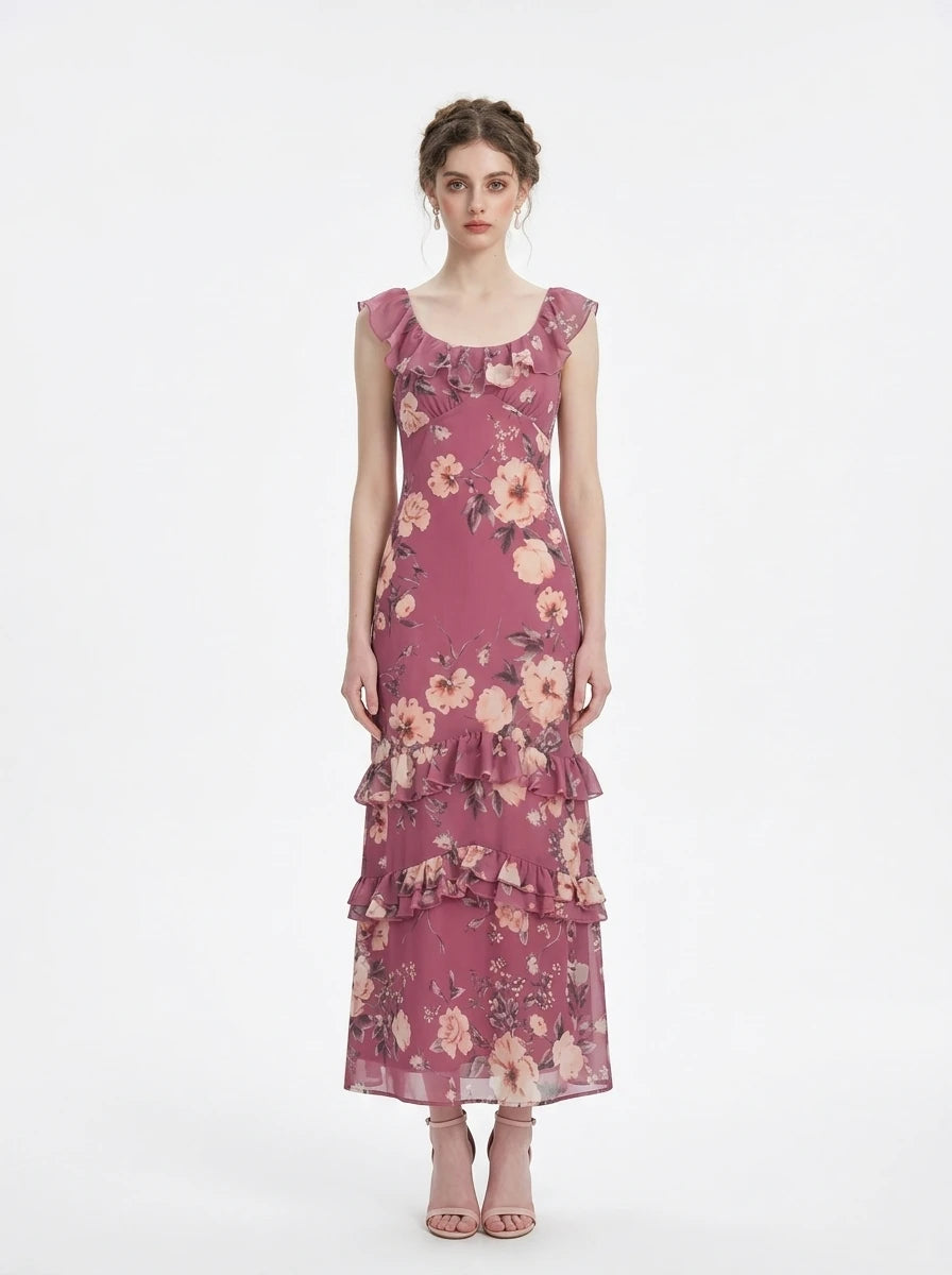 Woman wearing a floral print chiffon maxi dress with ruffled neckline and tiered skirt
