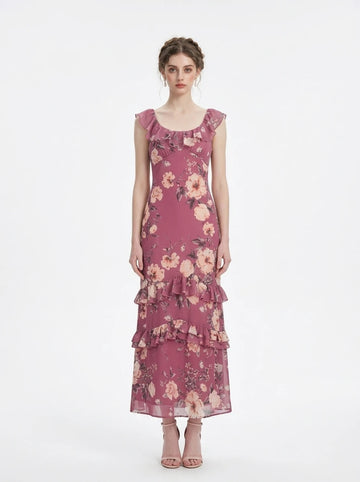Woman wearing a floral print chiffon maxi dress with ruffled neckline and tiered skirt