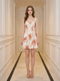 Woman wearing a white floral print A-line dress with a sweetheart neckline and adjustable shoulder straps, standing in a hallway.