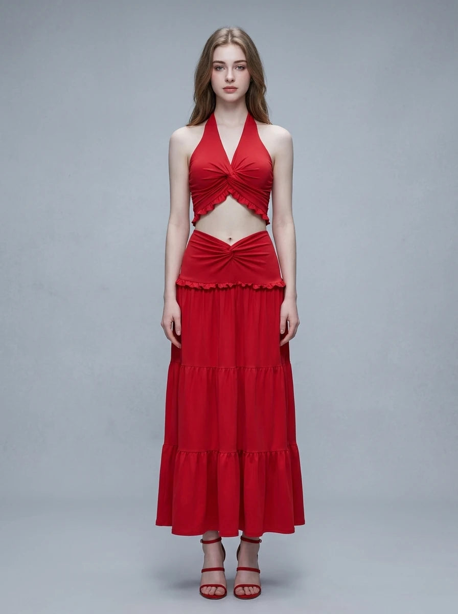 Woman wearing a red halter neck crop top and a tiered maxi skirt.
